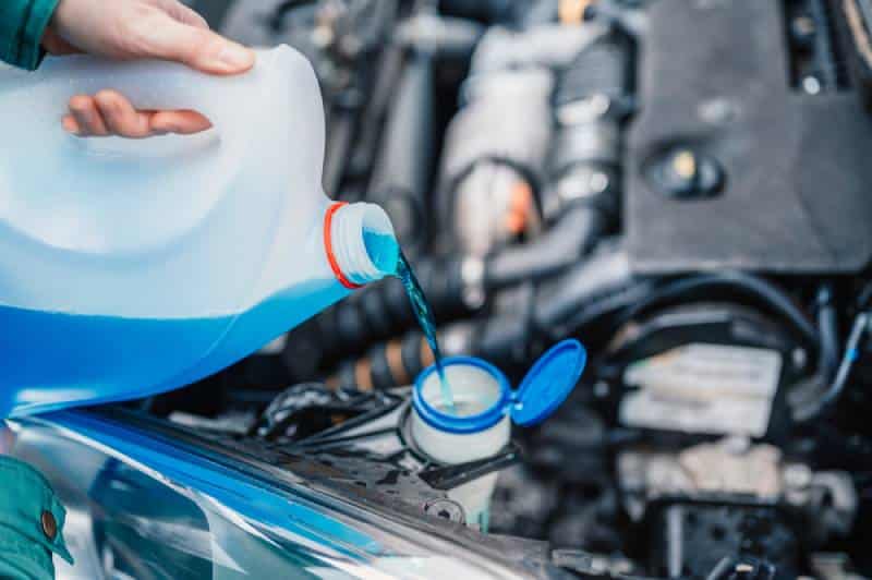 pouring antifreeze into car