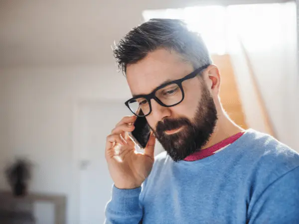 A person on the phone with an emergency hotline to consult about a situation wherein a dog ate marijuana