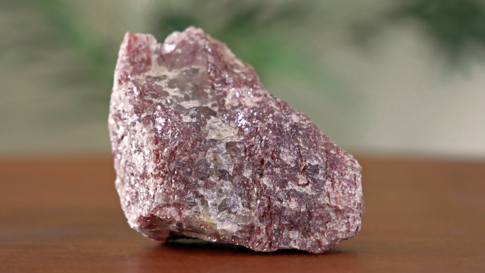 Raw-Lepidolite-on-wooden-table