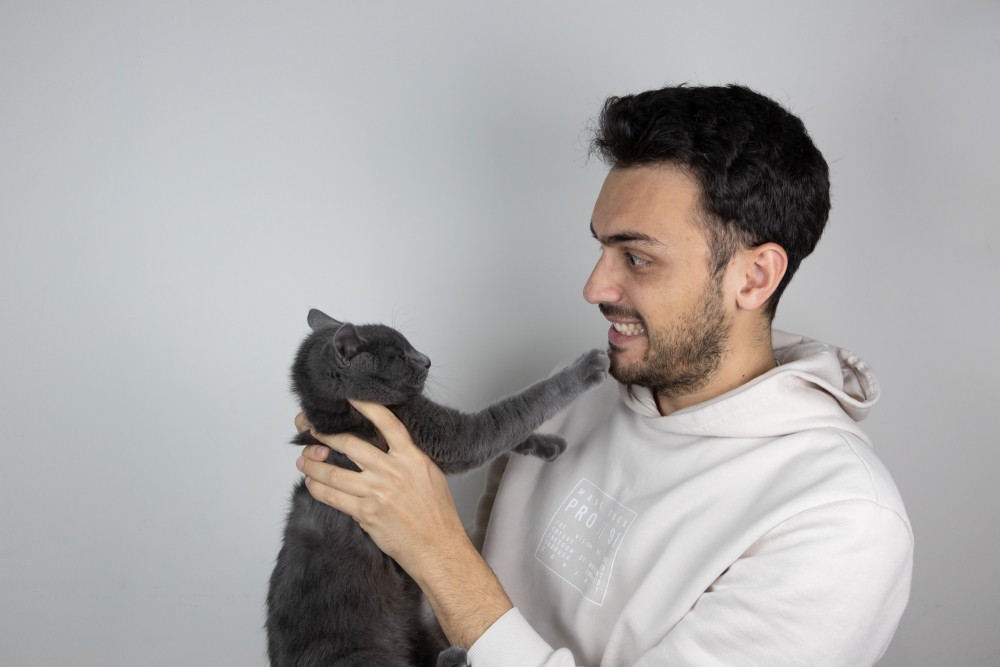 man holding a aggressive angry cat